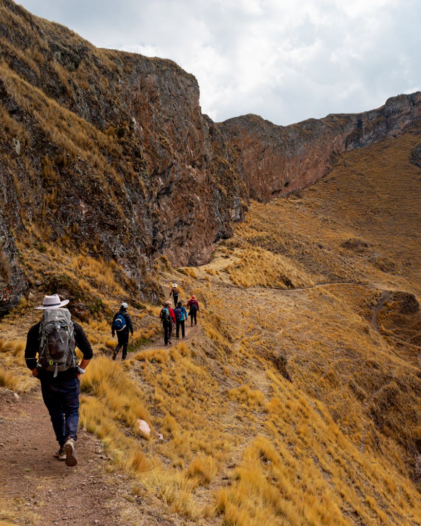 Hikers traverse a rugged path in the Andes mountains